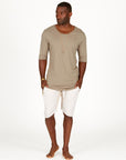 A man modeling white stone milanos mid shorts