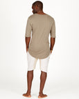 A man modeling white stone milanos mid shorts