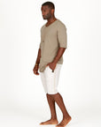 A man modeling white stone milanos mid shorts
