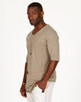 A man modeling white stone milanos mid shorts