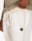 A man modeling white stone milanos mid shorts