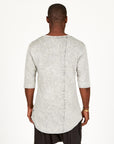 A man modeling in a grey mineral sweater v neck shirt