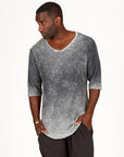 A man modeling in a grey mineral sweater v neck shirt