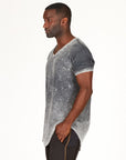 A man modeling in a grey mineral sweater v neck shirt