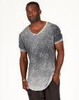 A man modeling in a grey mineral sweater v neck shirt