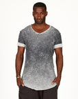 A man modeling in a grey mineral sweater v neck shirt