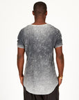 A man modeling in a grey mineral sweater v neck shirt