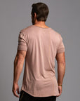 Male modeling light pink crew neck shirt