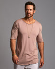 Male modeling light pink crew neck shirt