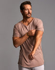 Male modeling light pink crew neck shirt