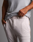Man modeling the milano pant in white stone