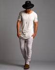 Man modeling the milano pant in white stone