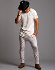 Man modeling the milano pant in white stone