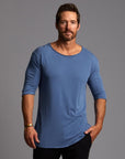Male modeling blue crew neck shirt