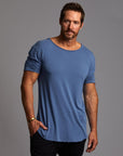 Male modeling blue crew neck shirt