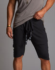 A man modeling charcoal blue milanos mid shorts
