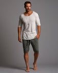 A man modeling urban forest green milanos mid shorts