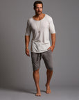 A man modeling deep clay gray milanos mid shorts