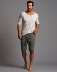 A man modeling urban forest green milanos mid shorts