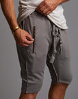 A man modeling deep clay gray milanos mid shorts