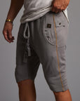 A man modeling deep clay gray milanos mid shorts