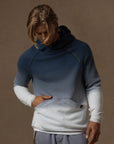 a male modeling the pullover plush hoodie in a grey gradient