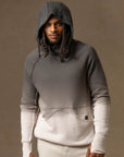a male modeling the pullover plush hoodie in a grey gradient