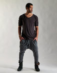 A man modeling tree pant in mineral wash