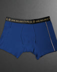 Blue boxer briefs with a black waistband featuring 'One Golden Thread' branding