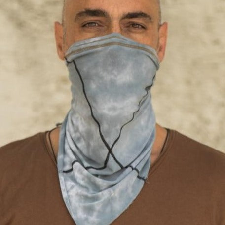 A man wearing the One Golden Thread Versawrap as a face covering in Sea Cloud TieDye color