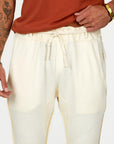 Man modeling the milano pant in white stone