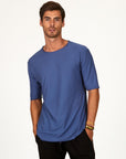 Male modeling blue crew neck shirt