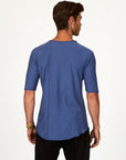 Male modeling blue crew neck shirt