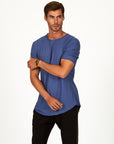 Male modeling blue crew neck shirt