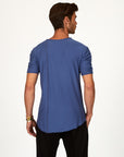 Male modeling blue crew neck shirt