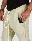 Man modeling the milano pant in ceremony sand