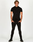 Man modeling a milano pants in black