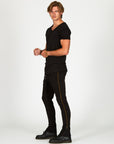 Man modeling a milano pants in black