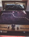 A bed with the One Golden Thread Pillow Face Set in the Black Onyx Bolt and Calico Cloud colors
