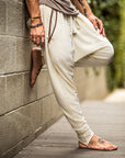 A man wearing the One Golden Thread Tree Pant in Ceremony Sand color