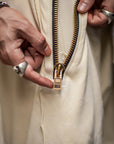 A man wearing the One Golden Thread Tree Pant in Ceremony Sand color