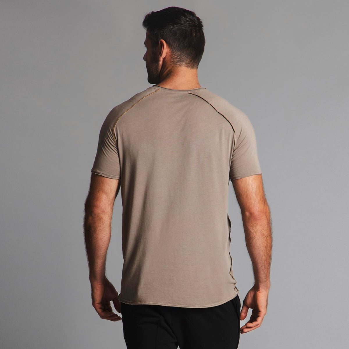 Male modeling tan crew neck shirt
