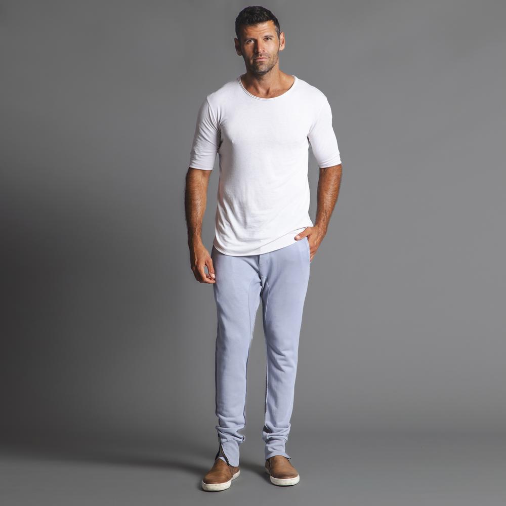 Man modeling the milano pant in blue clay