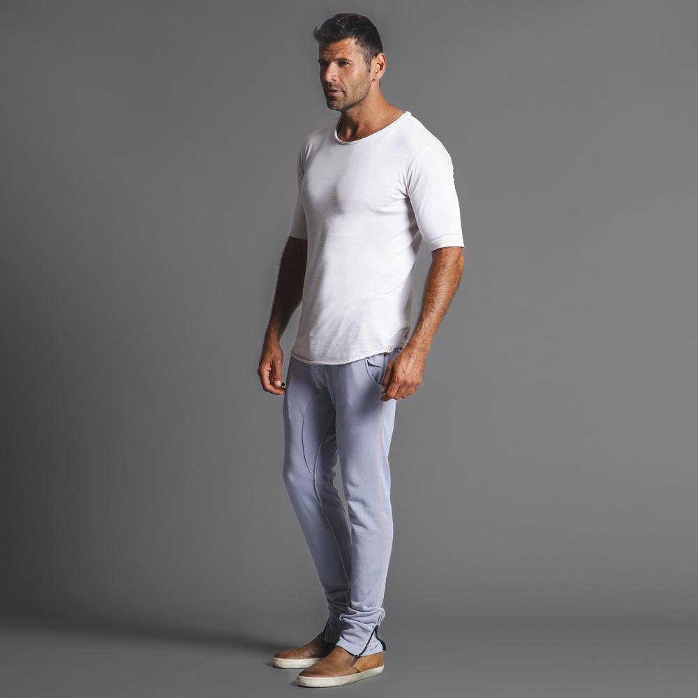 Man modeling the milano pant in blue clay