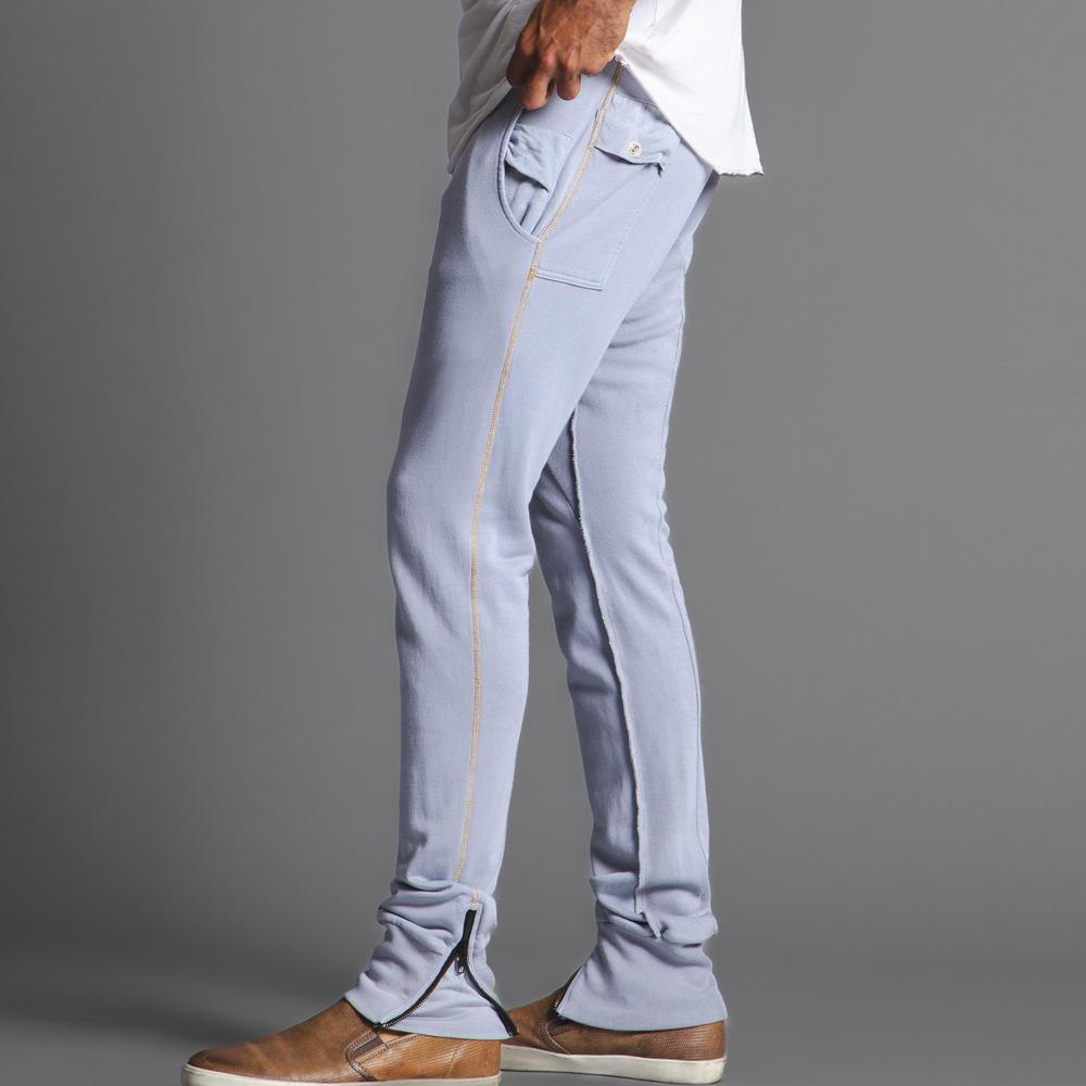 Man modeling the milano pant in blue clay