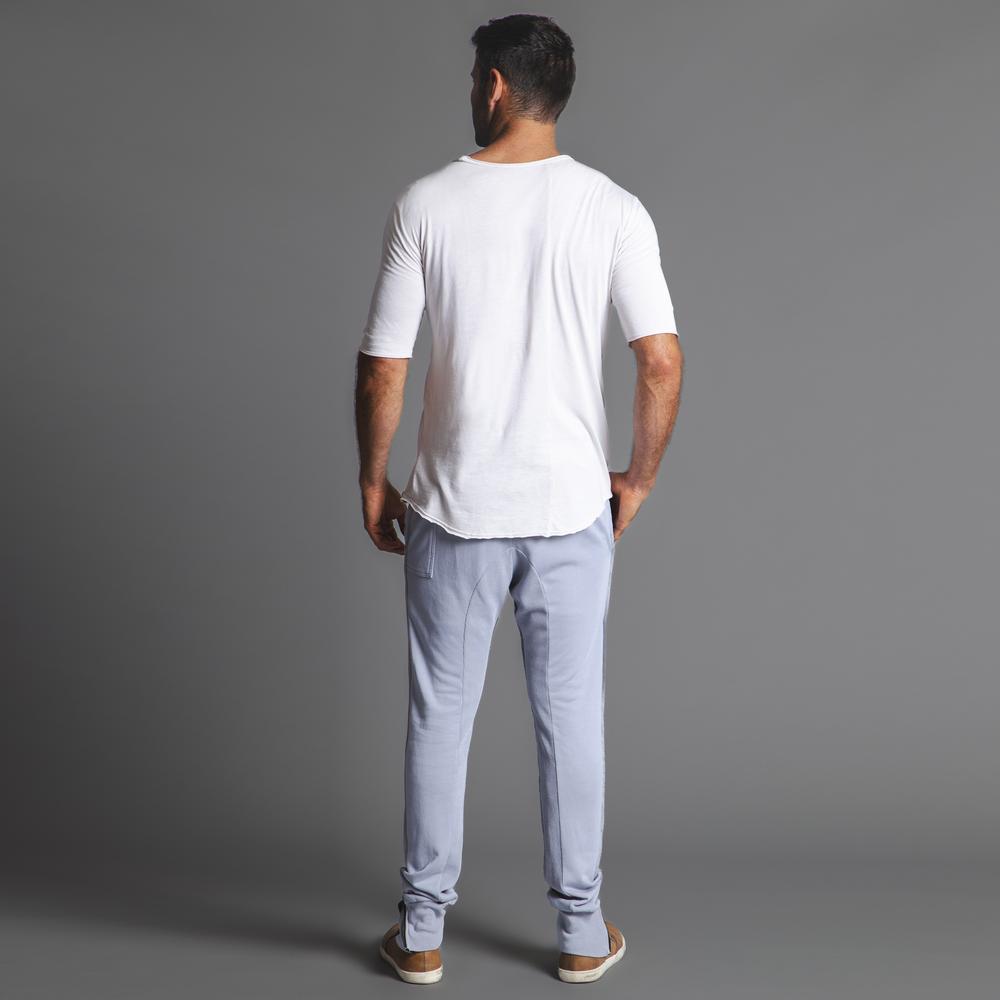 Man modeling the milano pant in blue clay