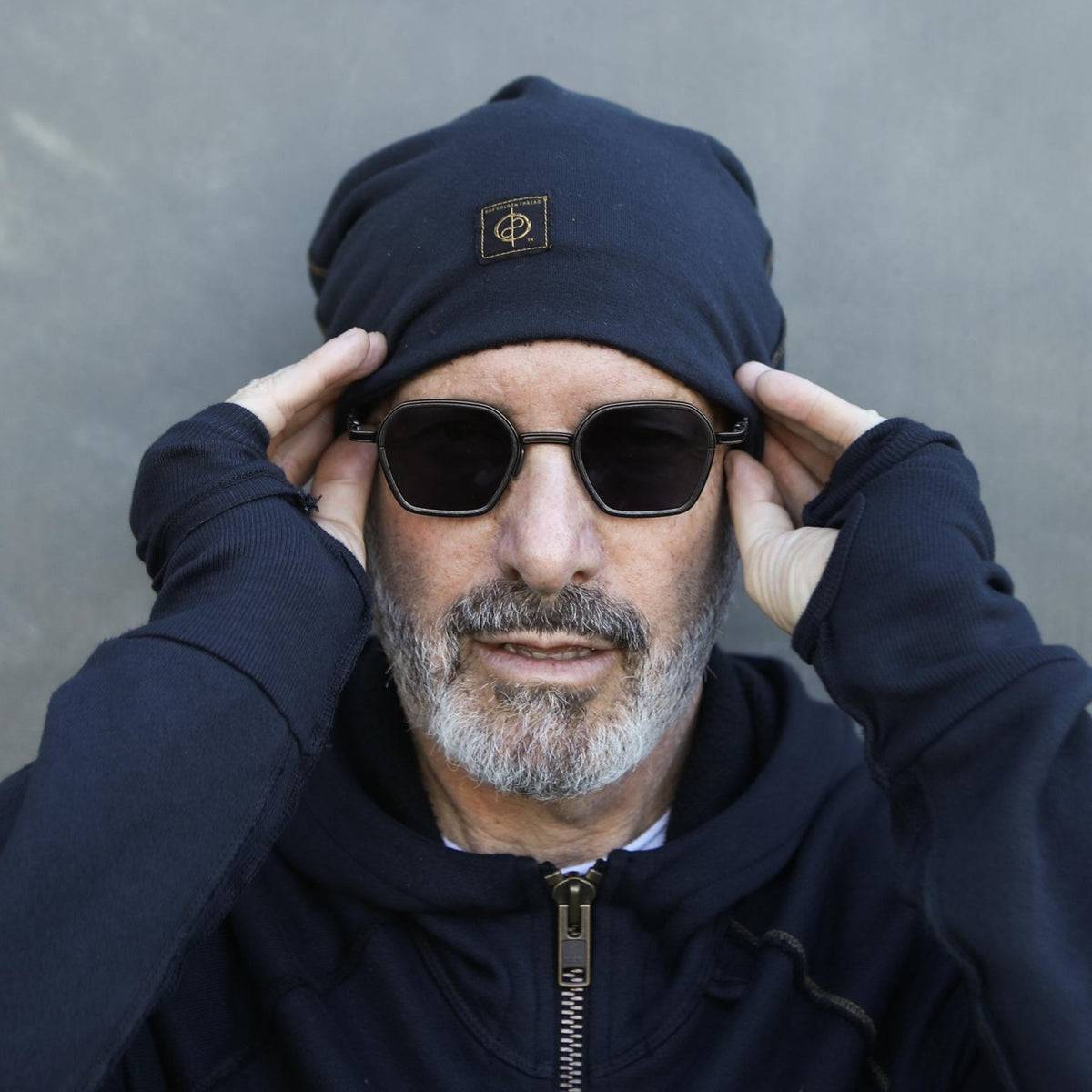 A man modeling the One Golden Thread OG Cloud Beanie in Charcoal Blue