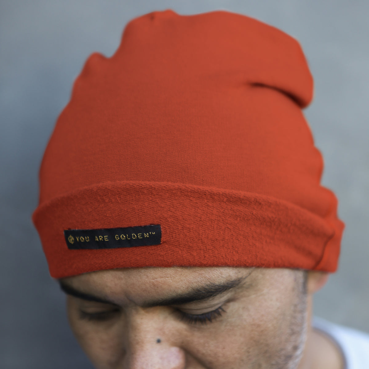A man modeling the One Golden Thread OG Cloud Beanie in Terra