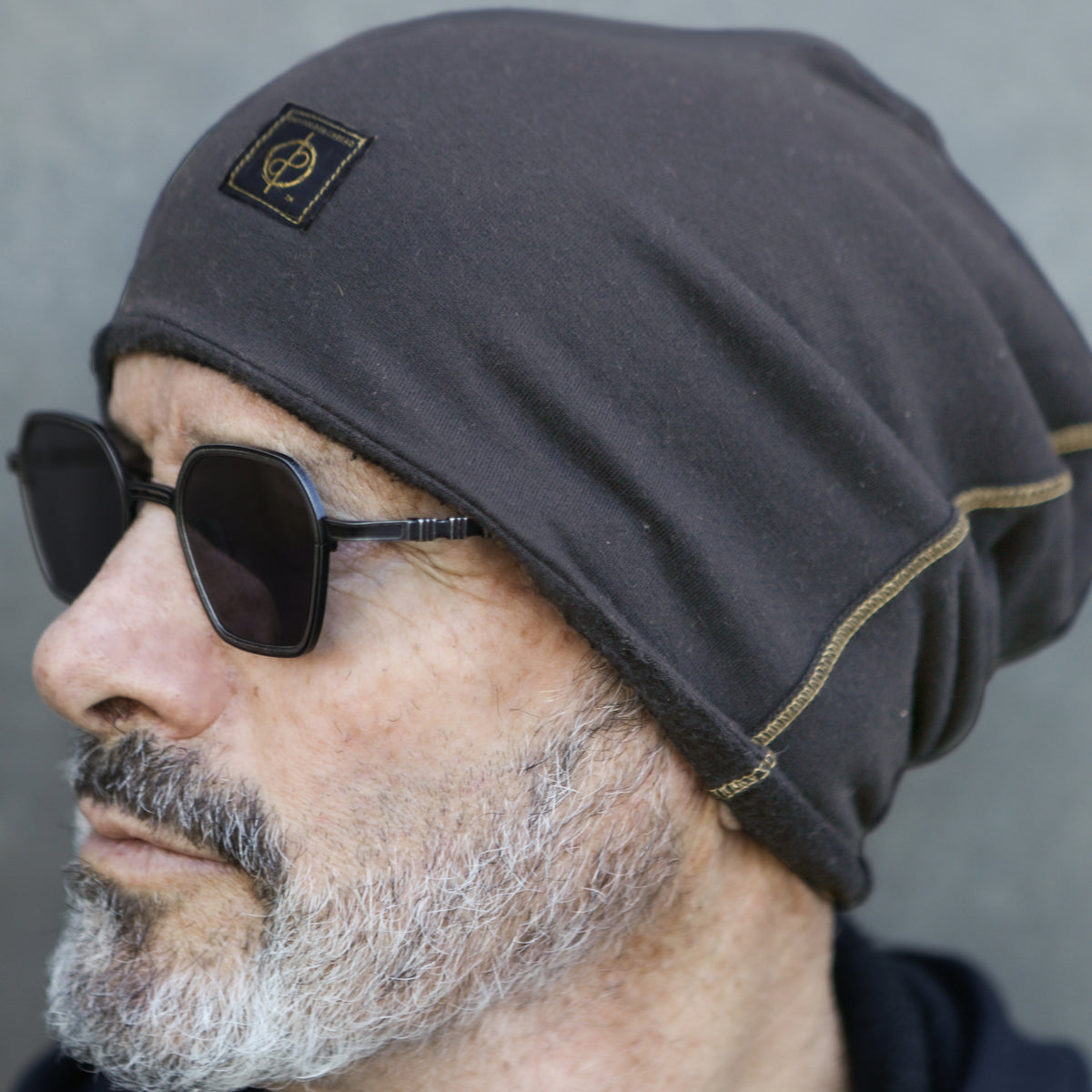 A man modeling the One Golden Thread OG Cloud Beanie in Slate