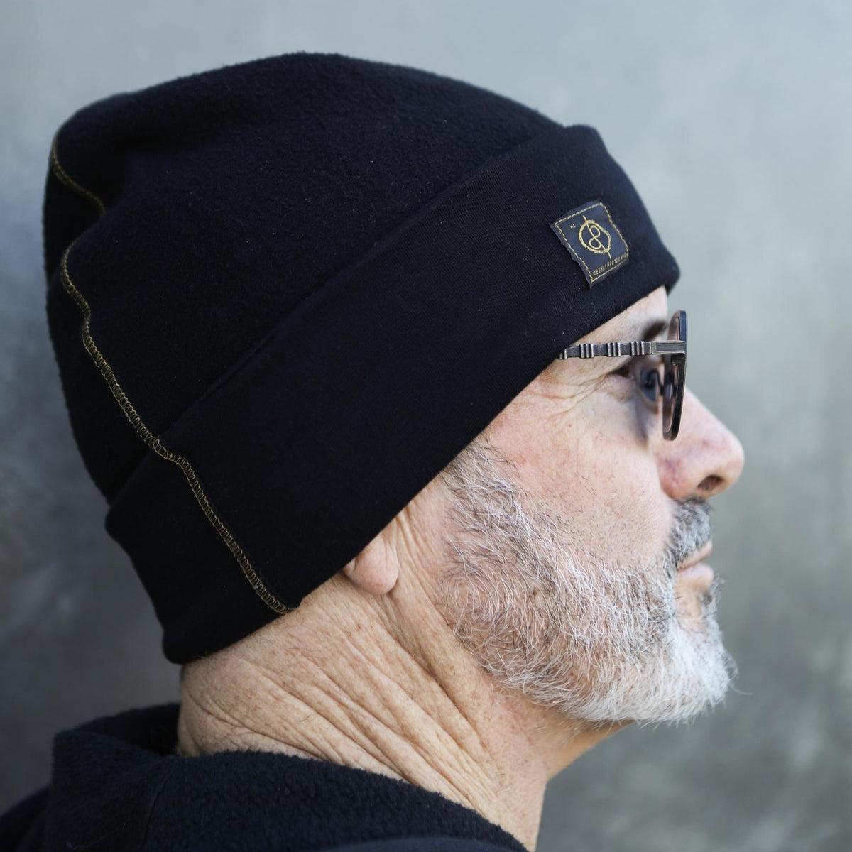 A man modeling the One Golden Thread OG Cloud Beanie in Black